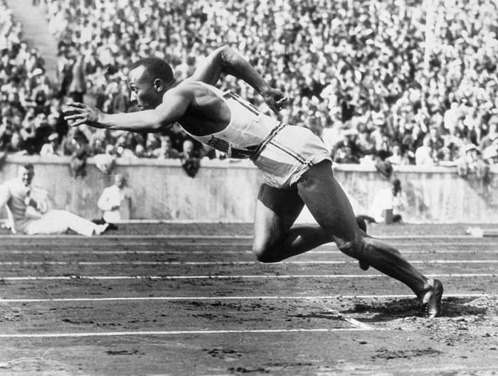 Jesse Owens wins the gold at 1936 Olympics