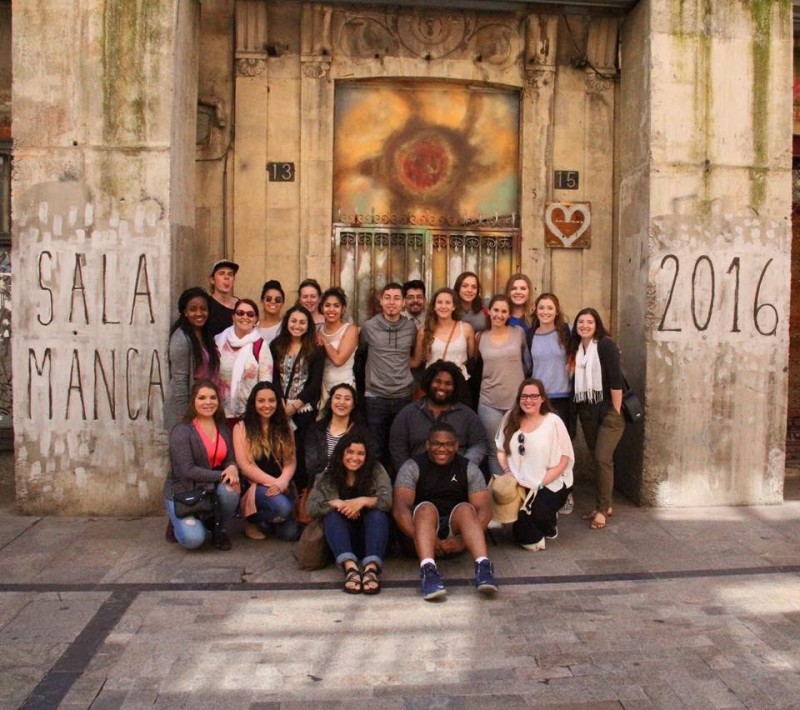 students in front of a painted door in salamanca spain