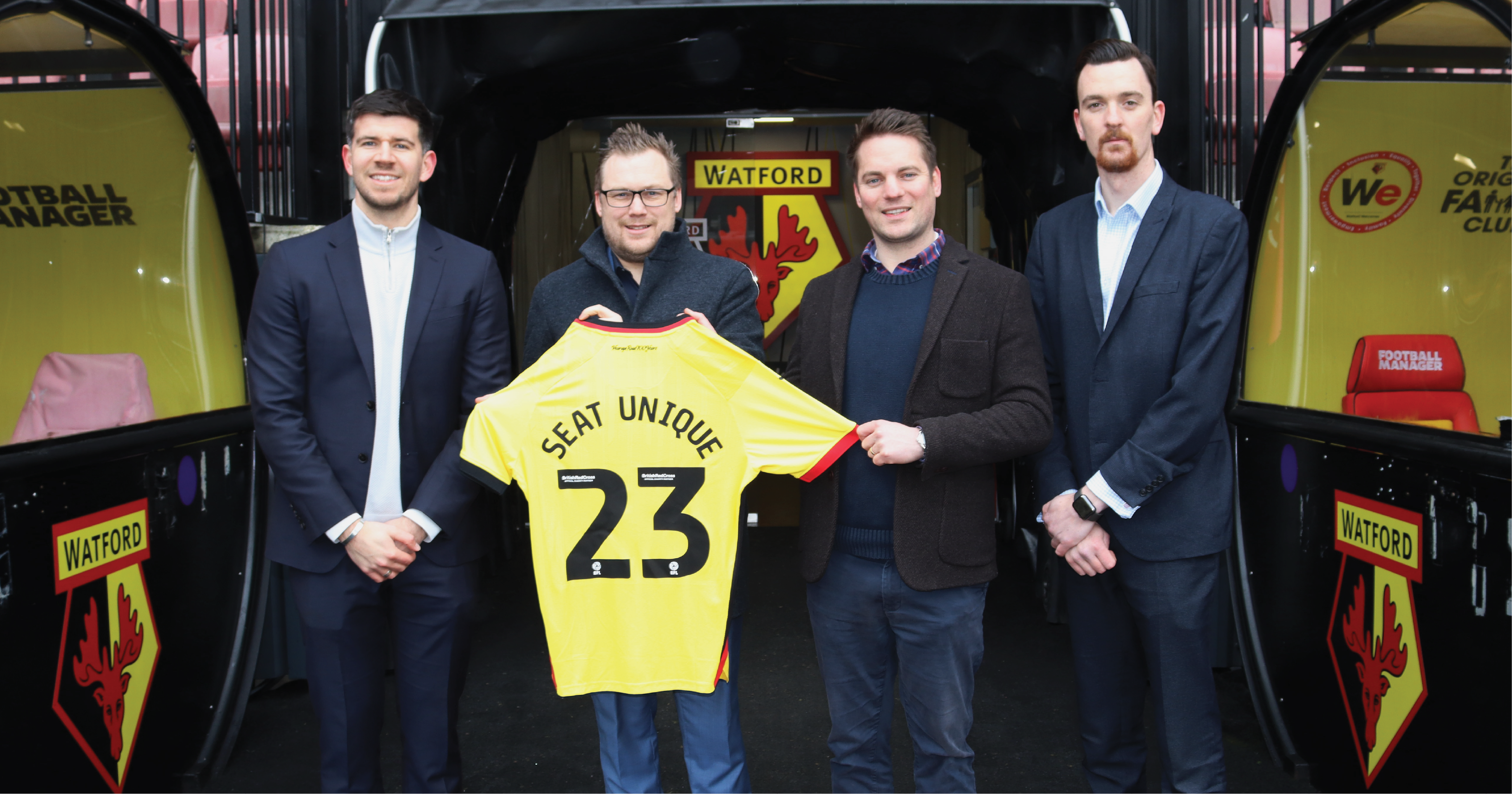 Seat Unique and Watford FC team holding Watford FC shirt