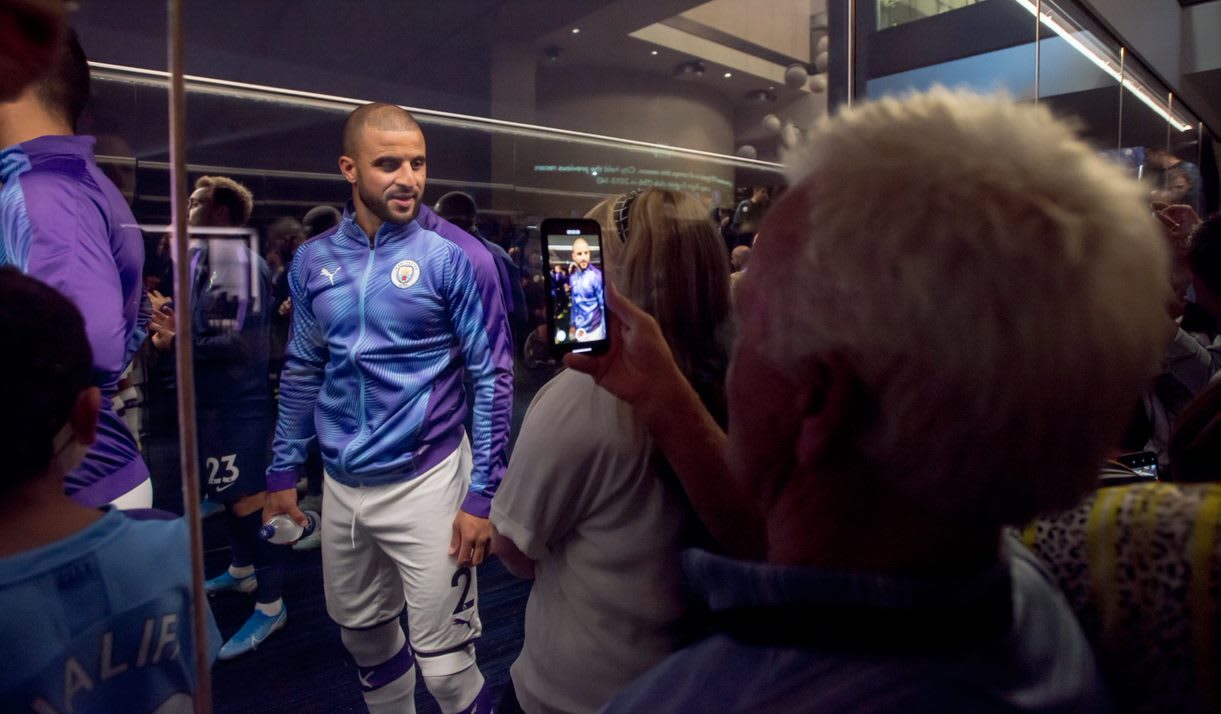 Fans in the Tunnel Club hospitality taking pictures of the Man City players as they line up in the tunnel.
