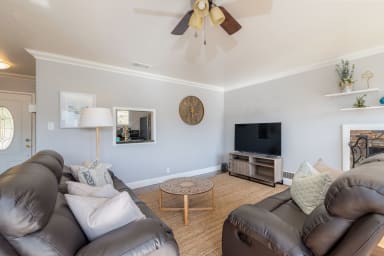 Inviting living room with sofa, fireplace, and entertainment