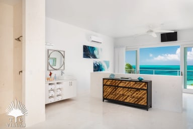 Villa Sandpiper's master bedroom with ensuite bath and views of Grace Bay.