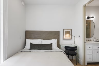 1 Queen Bed with 1 small working table with 1 chair