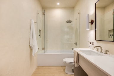 Bathroom with combination tub and rain shower + high-end toiletries