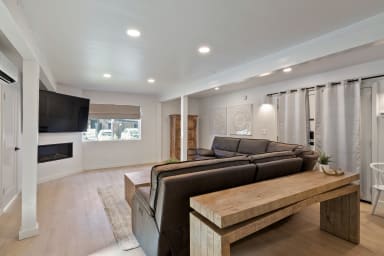 A spacious living room, complete with a comfortable sofa for relaxing.