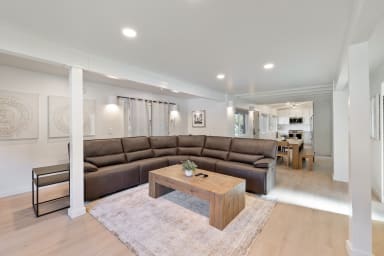 A spacious living room, complete with a comfortable sofa for relaxing.