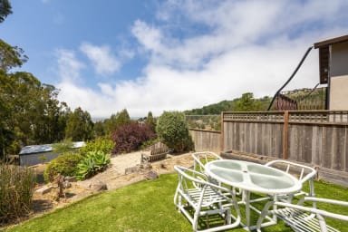 Spacious backyard with stylish chairs and table