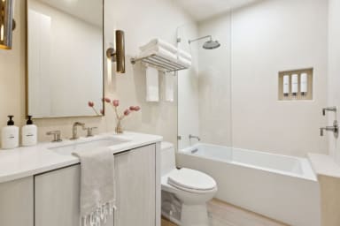 En-suite bathroom with tub, rain shower, custom vanity & high-end toiletries