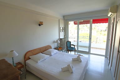 Air-conditioned bedroom with a double bed, opening onto a terrace and a view.