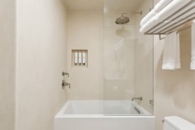 En-suite bathroom with rain shower, bathtub, and high-end toiletries