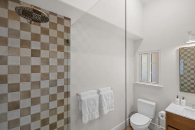 En-suite bathroom with rain shower and Public Goods toiletries.