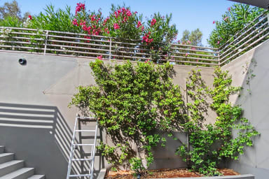 Lush garden oasis beside the villa stairs, perfect for a tranquil stroll.