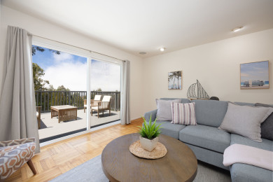Stylish living room with sofas opening to the terrace