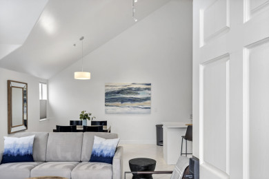 Cozy lounge with sofa, TV, and inviting fireplace for relaxing moments