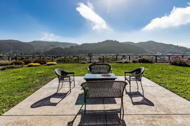 Spacious outdoor seating with table, chairs, and a beautiful ocean view