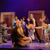 Kev Orkian as Mahmud (centre) and company