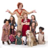 Craig Revel Horwood as Miss Hannigan with Annie and orphans