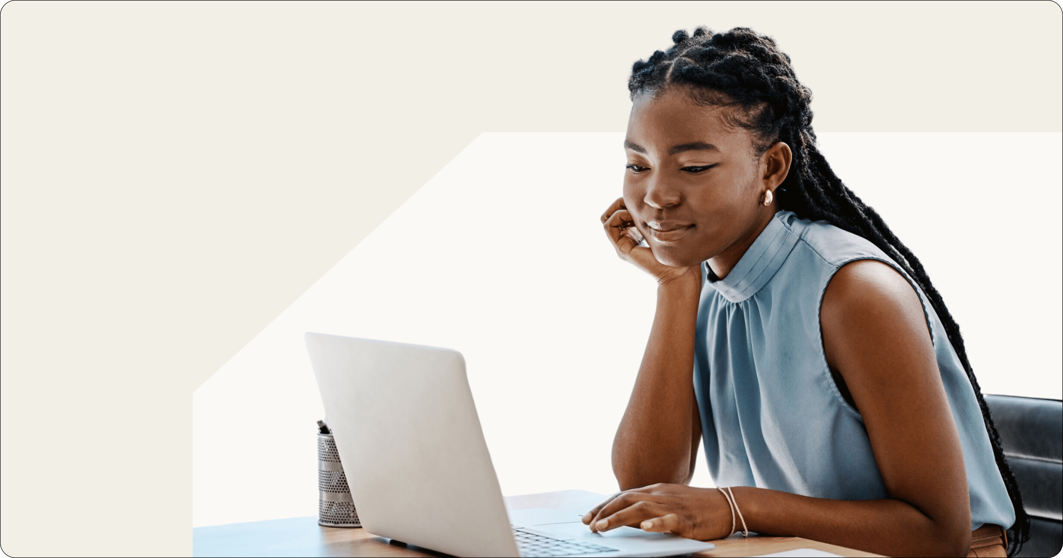 young black woman logging into laptop in office setting