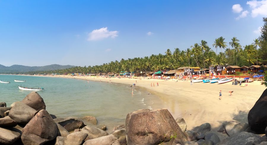 goa beach with people on the shore in India