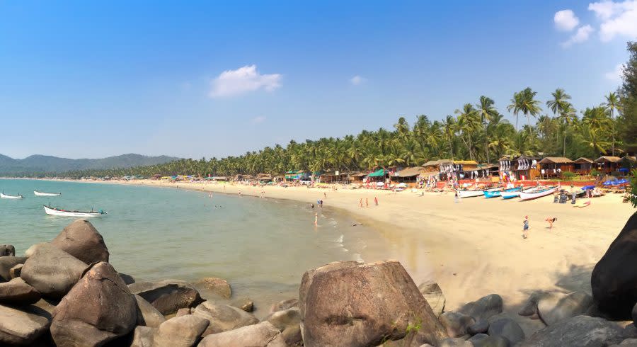goa beach with people on the shore in India