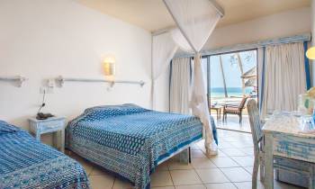 a bedroom with a bed and a chair in a room