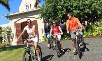a group of people riding on the back of a bicycle