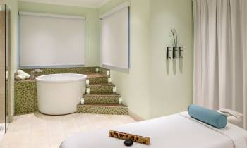 a bedroom with a bed and a mirror