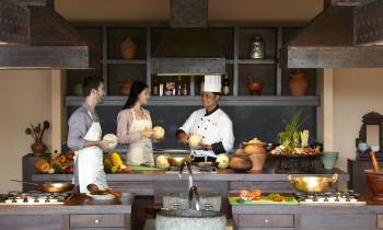 a man and woman cooking food in a kitchen