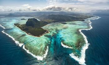 a body of water with a mountain in the background