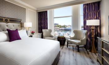a bedroom with a large bed in a hotel room