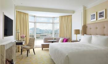 a bedroom with a large bed in a hotel room