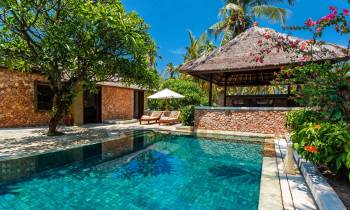 a house with a pool outside of a building