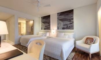 a bedroom with a large bed in a hotel room