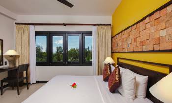 a bedroom with a bed in a room