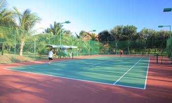 a person on a court with a racket
