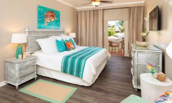 a bedroom with a bed and a table in a room