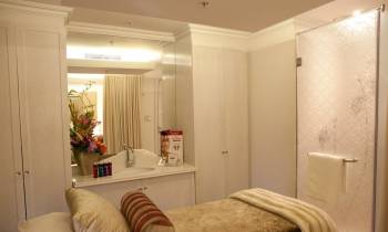 a bedroom with a bed and a mirror
