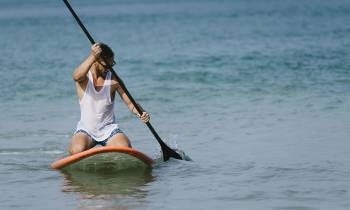 a person riding a surf board on a body of water