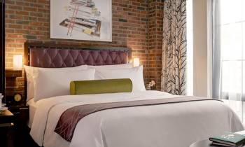 a hotel room with a bed and a window