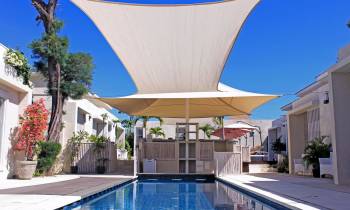 a large building with a pool in front of a house
