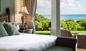 a hotel room with a bed and chair