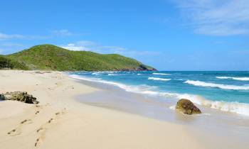 a sandy beach next to the water