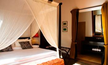 a bedroom with a bed and a mirror