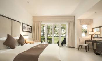 a bedroom with a large bed in a hotel room