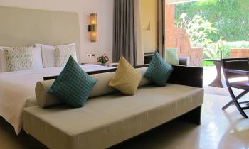 a hotel room with a couch and a table