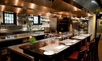 a large commercial kitchen with stainless steel appliances