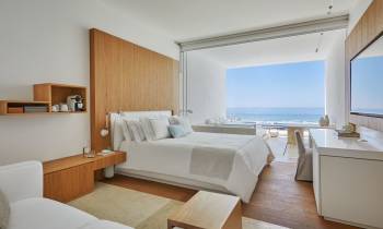 a living room with a bed and a large window