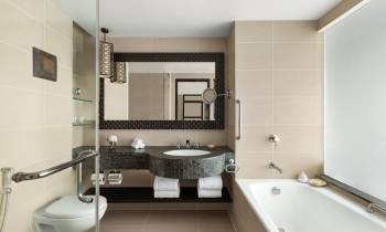a white sink sitting under a mirror