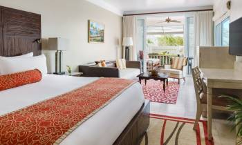 a bedroom with a bed and a chair in a room