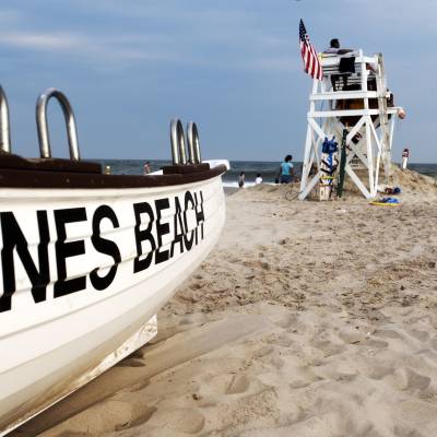 a boat sitting on top of a sandy beach